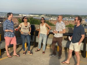 Friends enjoying drinks and views of Casco Bay and the Old Port