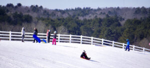 people sledding down a hill